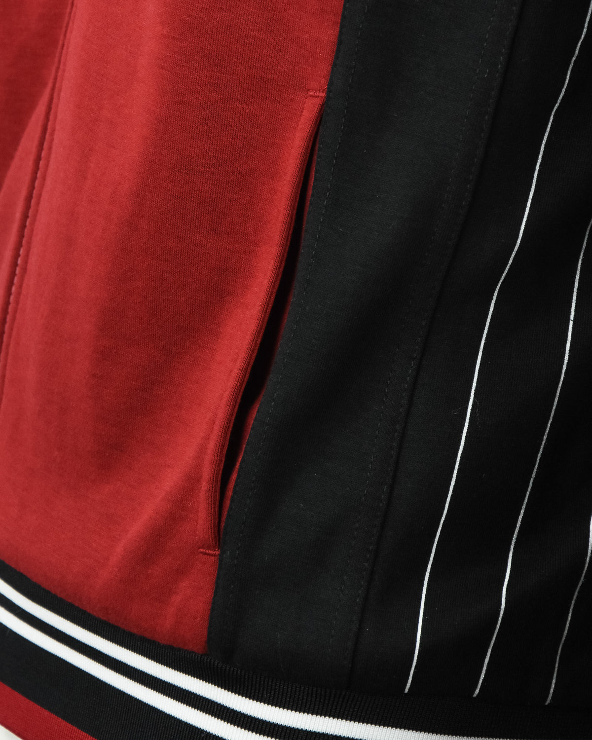 Close-up of red front with black contrast panel and white piping stripe accents.