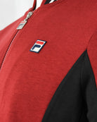 Red jacket chest with F-logo patch and full zipper front detail, black side panel.
