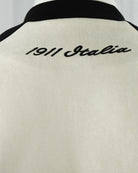 Fila Isaac jacket back close-up with “Isaac” script and black ribbed collar