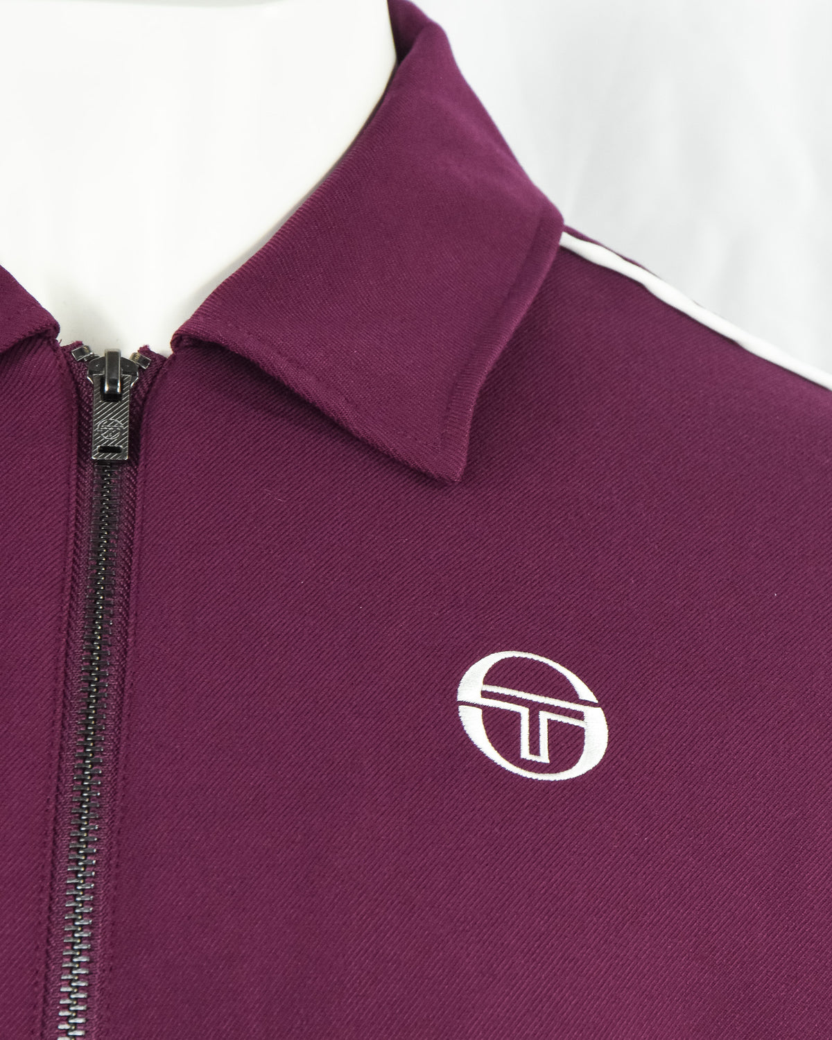 Purple track jacket zipper and Sergio Tacchini logo near chest