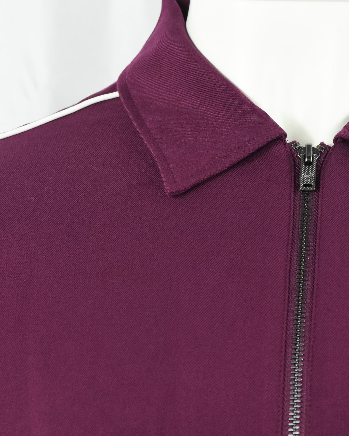 Purple track jacket shoulder seam with stand collar and zipper