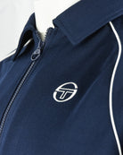 Navy track top chest logo with white piping along zipper placket