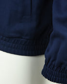 Navy track jacket hem with elastic waistband and cuff