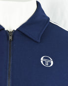 Navy track jacket quarter zip area with raised collar and white logo emblem