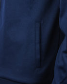 Navy track top jacket with vertical welt pocket detail and zip seam
