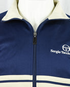 Navy track top jacket with metal zipper pull and cream stripe band at chest