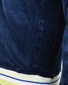 Velour track jacket hem detail in dark blue with striped rib trim