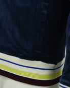 Dark blue velour track jacket with striped ribbed hem and cuff trim