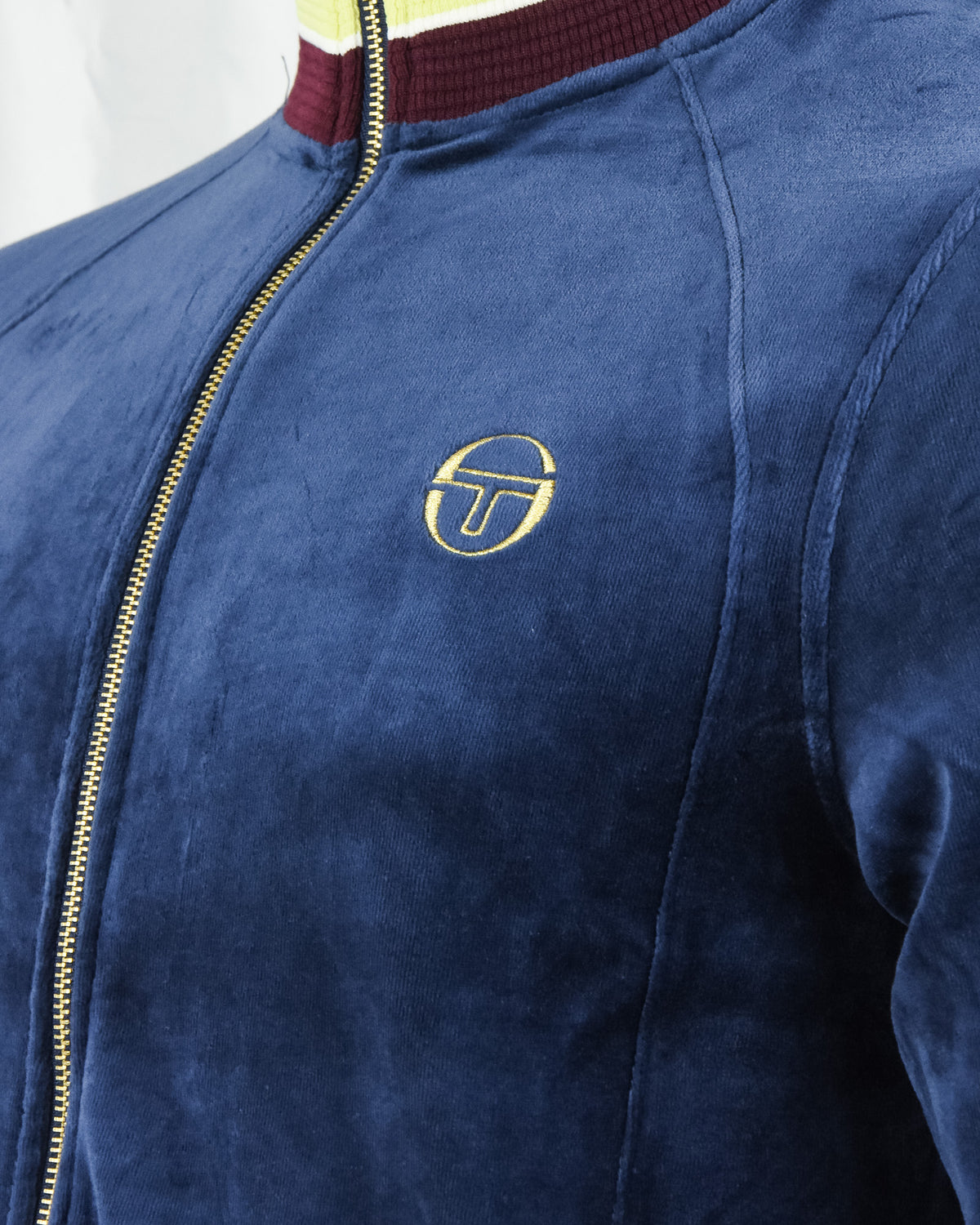 Dark blue velour track jacket with gold zipper and TT logo on the chest