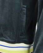 Dark teal velour jacket sleeve with ribbed striped cuff in blue, white, and lime