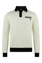 Cream knitted long-sleeve polo with black collar, button placket, and chest logo patch.