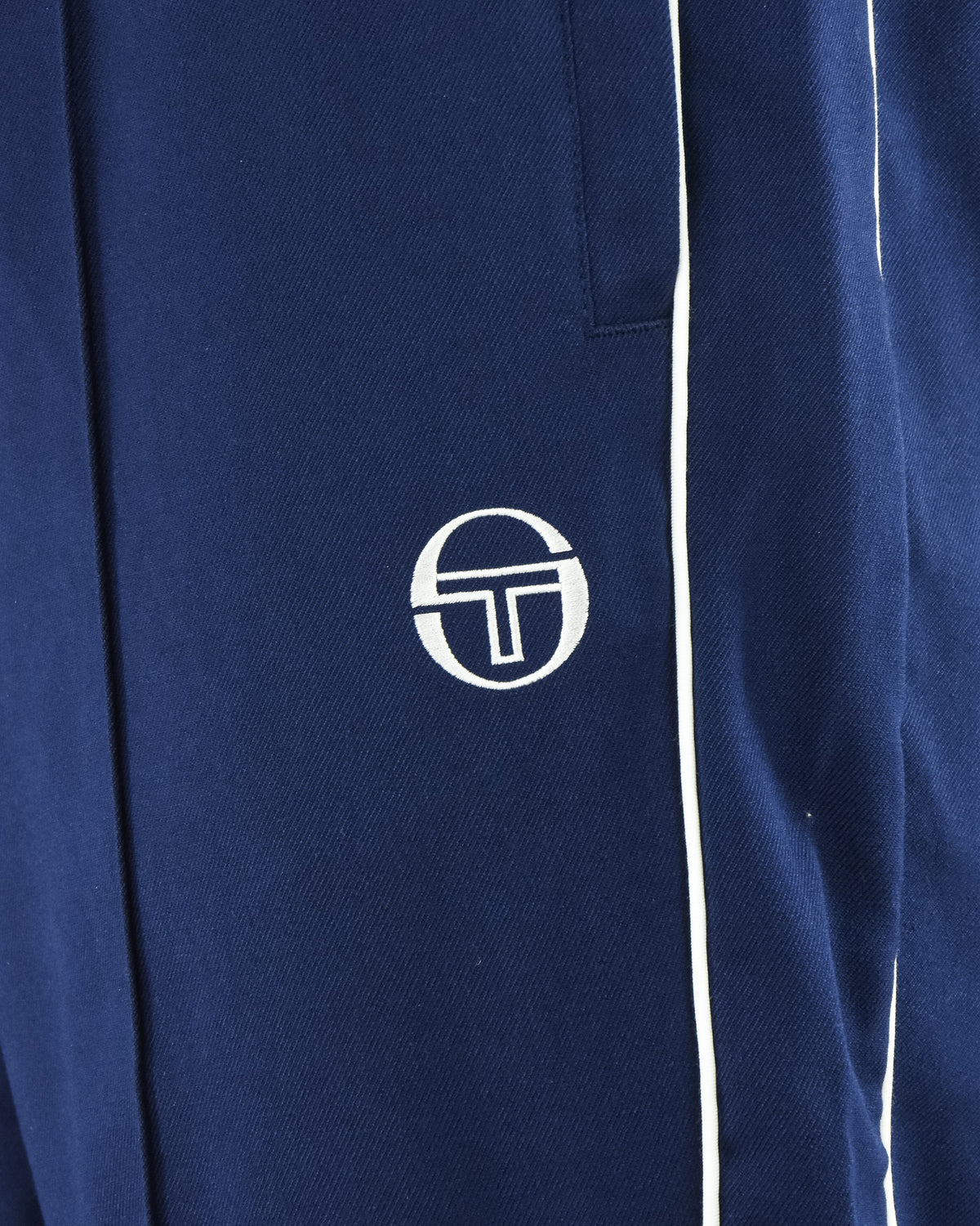 Navy track pants with Sergio Tacchini logo and white side stripe