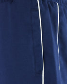 Navy track pants detail with side pocket and white piping stripe