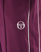 Burgundy track pants leg with white side stripe and Sergio Tacchini logo patch