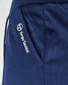 Navy track pants close-up with embroidered Sergio Tacchini logo and side pocket