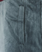 Velour track pants close-up: side seam and inner pocket detail
