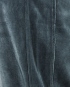 Velour track pants close-up: vertical front seam and fabric texture