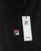 Black jogger pants with side logo patches and hang tag