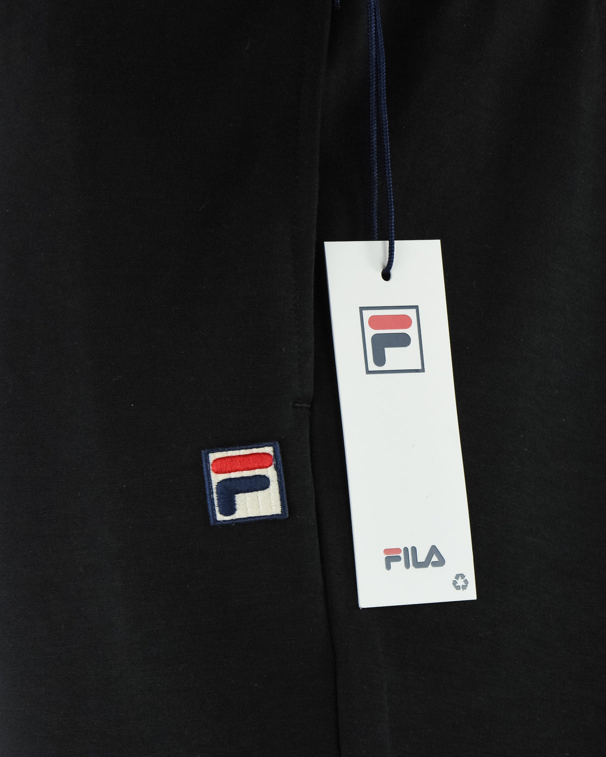 Black jogger pants with side logo patches and hang tag