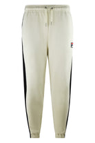 Colour-block track pants in cream with black side stripes, elastic cuffs and drawstring