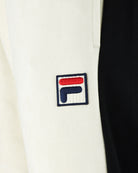 FILA logo patch on cream track pants with black side panel