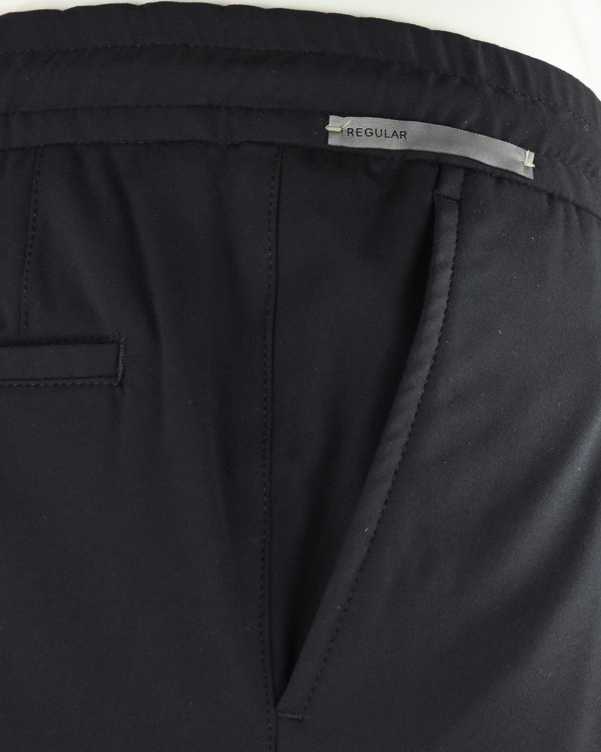 Black jersey stretch pant waistband with drawstring and inner seam detail