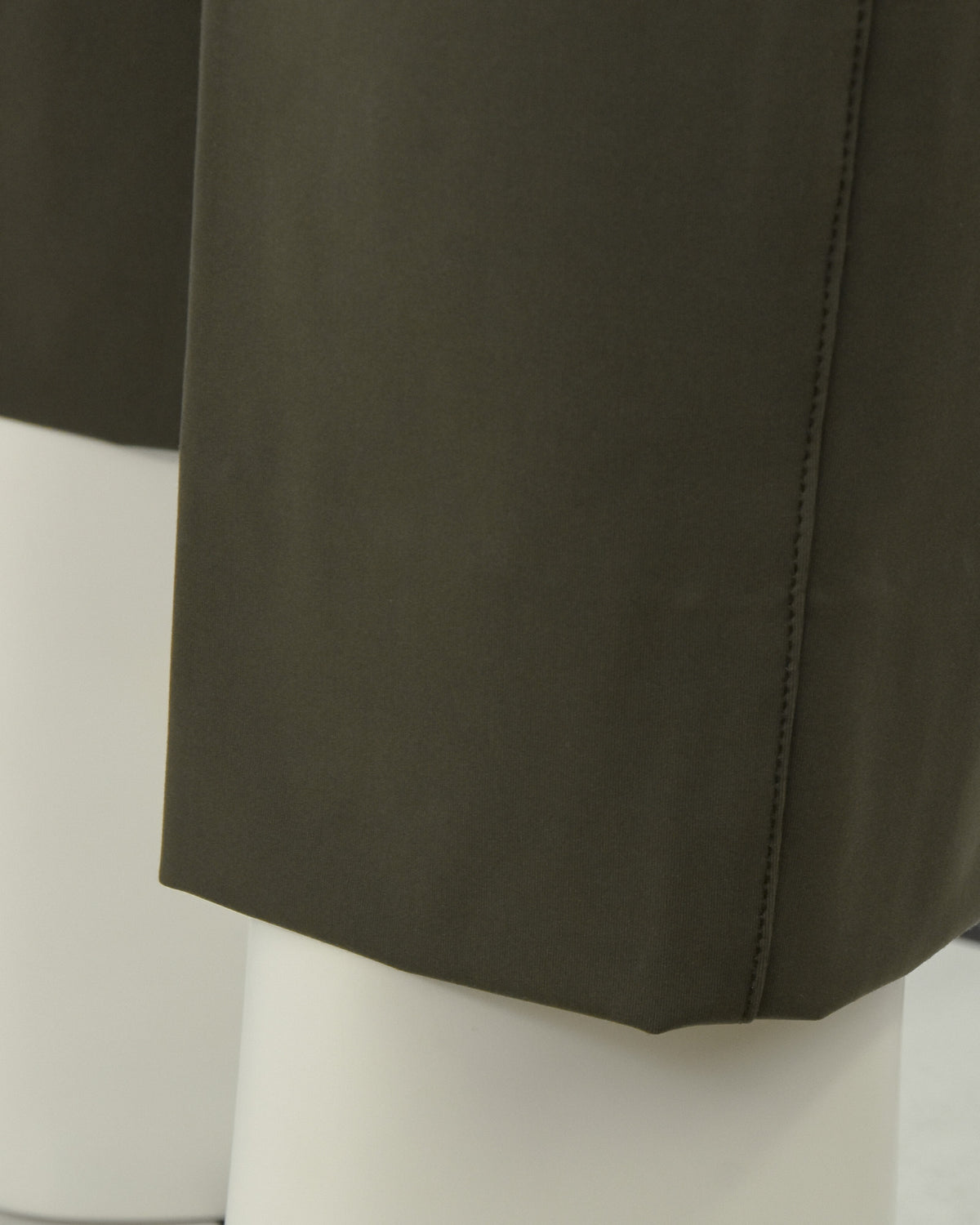 Olive pants hem and side seam with clean drape finish