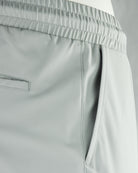 Stone grey tech pants side pocket and elastic waistband detail