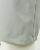 Stone grey tech pants hem and stitched pocket underlayer close-up
