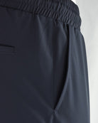 Navy tech pants with side pocket opening and elastic waistband