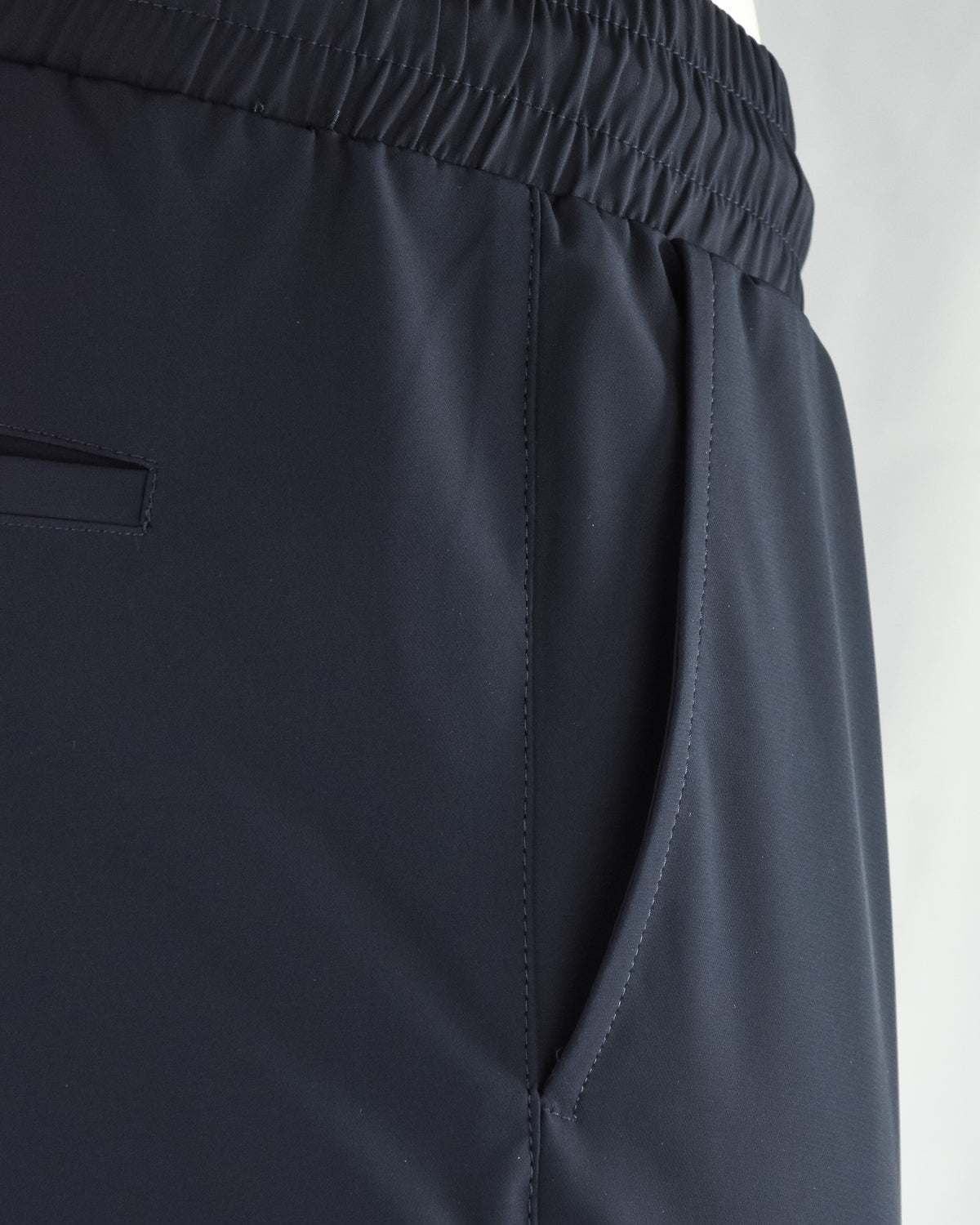 Navy tech pants with side pocket opening and elastic waistband