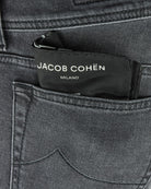 Jacob Cohen Milano waistband label on dark grey stretch denim jeans.