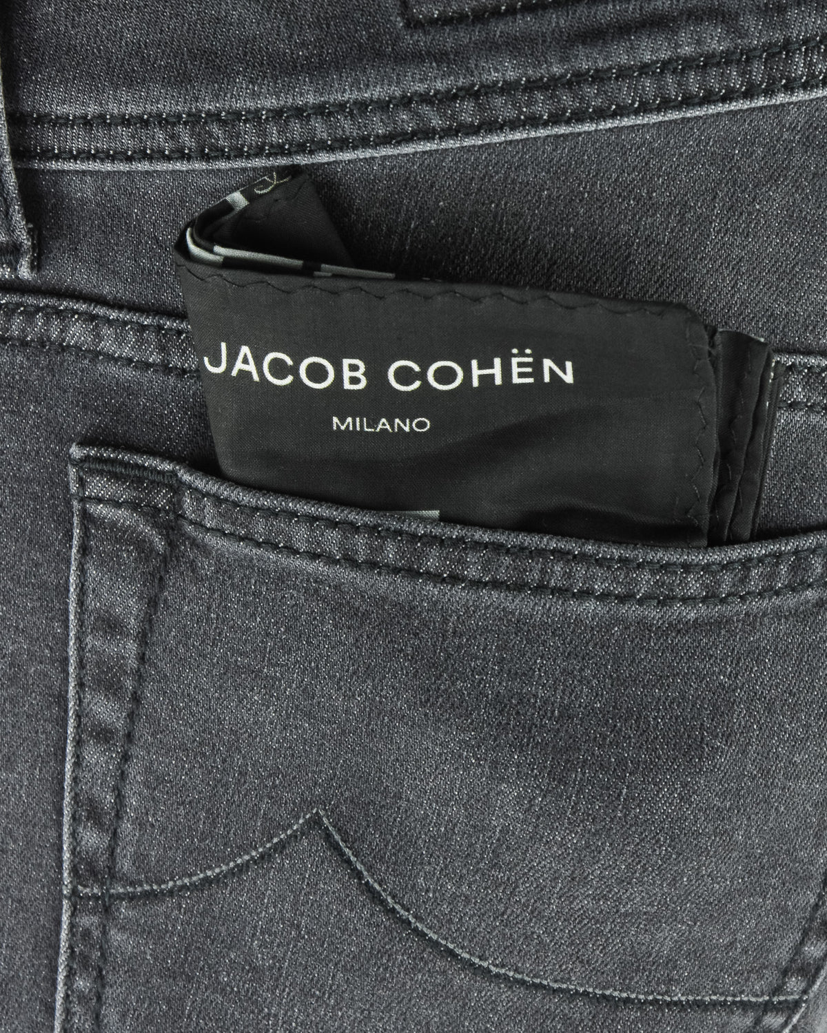 Jacob Cohen Milano waistband label on dark grey stretch denim jeans.