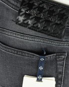 Star-pattern Jacob Cohen logo patch on dark grey jeans waistband.