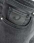 Dark grey jeans coin pocket with stitched logo detail.