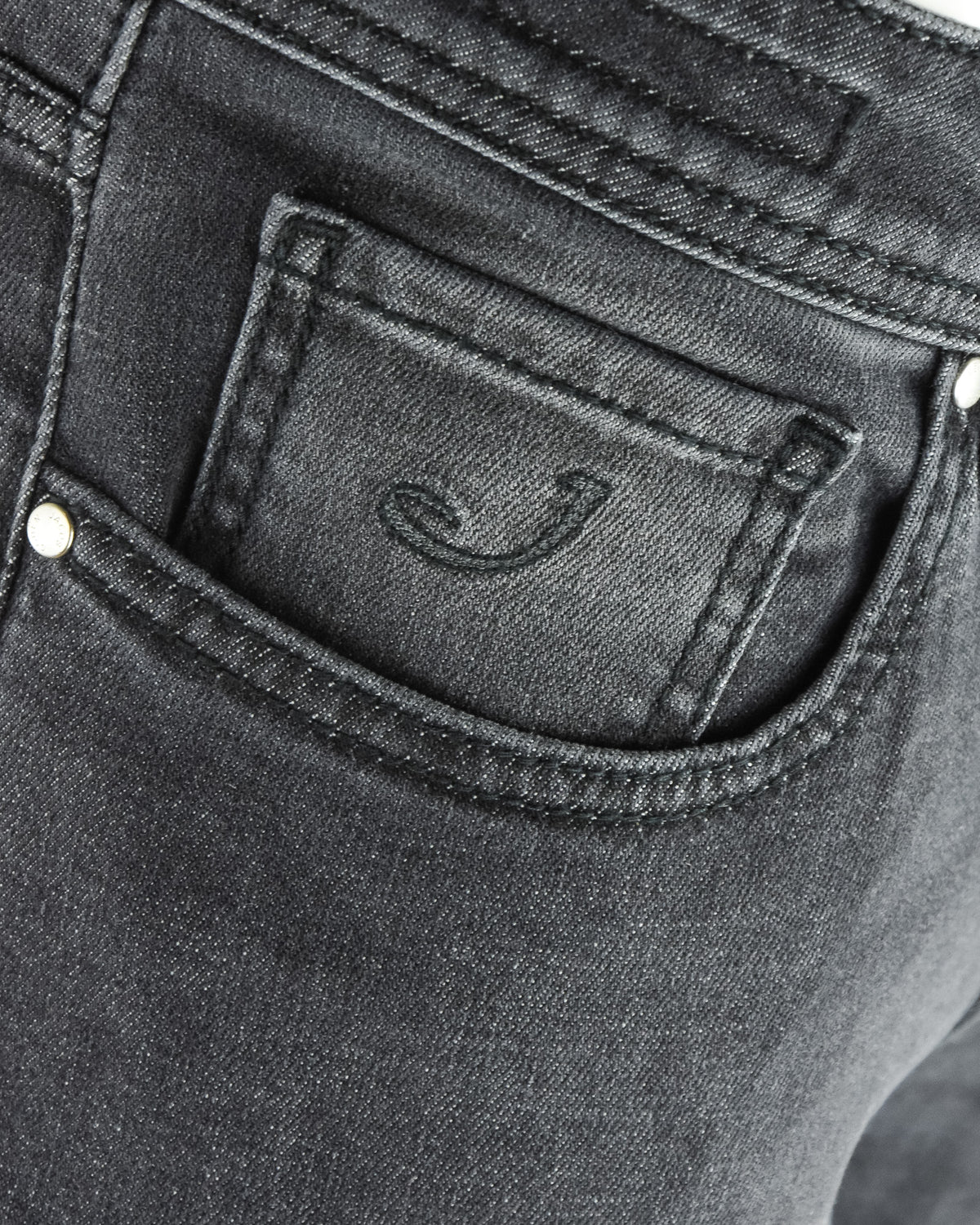 Dark grey jeans coin pocket with stitched logo detail.