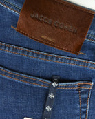 Brown leather brand label on blue denim pocket