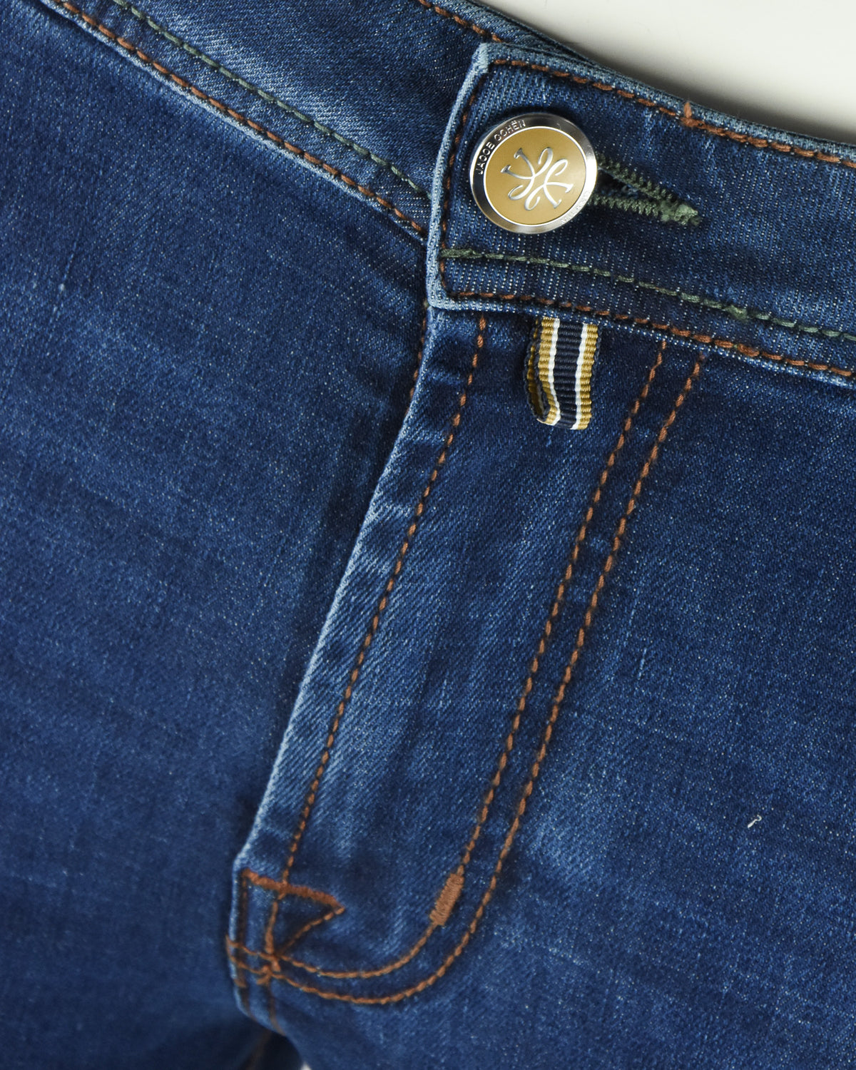 Medium-blue denim jeans with logo button and orange stitching detail