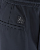 Navy tech pants with stitched logo patch on pocket flap