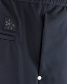 Navy tech pants with logo patch and front pocket seam