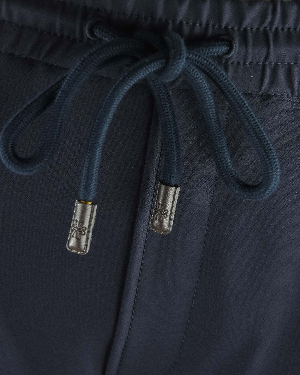 Navy drawstring waist with braided cords and metal aglets