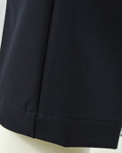 Navy tech pants hem with side seam and clean stitched finish