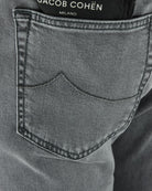 Front pocket detail on light grey denim jeans with contrast topstitching