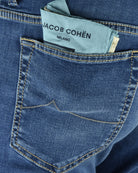 Blue denim front pocket with contrast yellow stitching and logo label