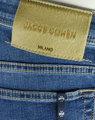Blue denim jeans with Jacob Cohen Milano logo patch on waistband