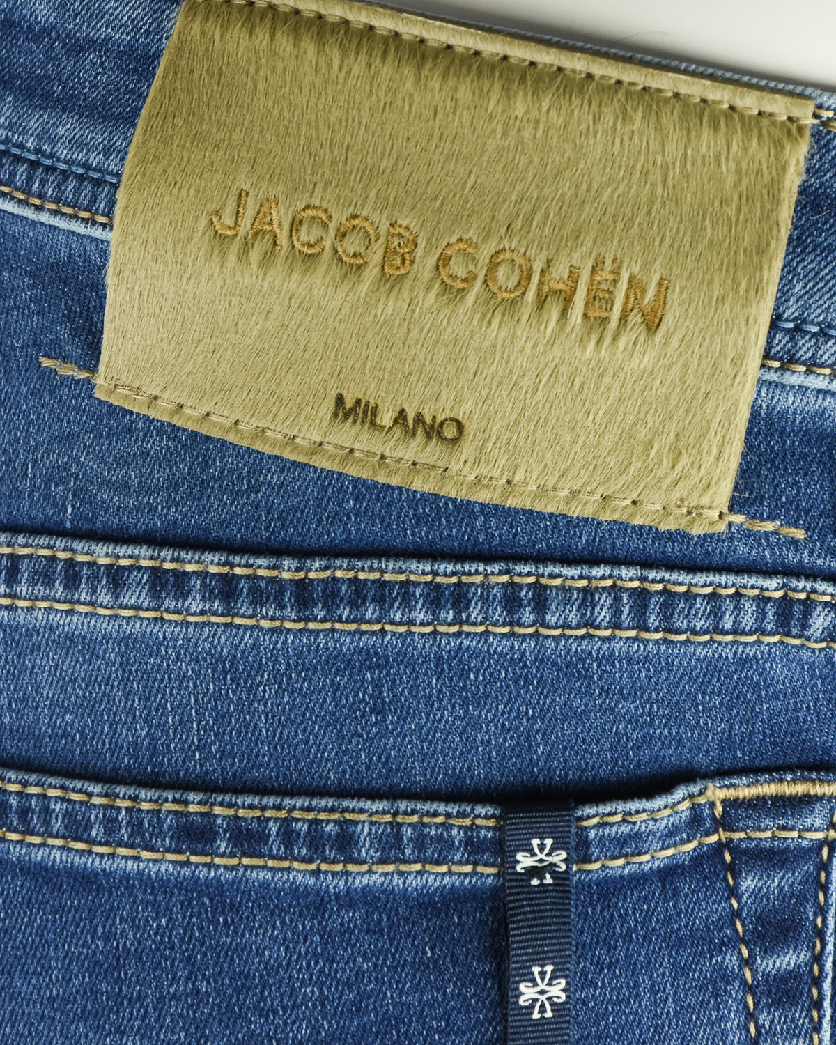 Blue denim jeans with Jacob Cohen Milano logo patch on waistband
