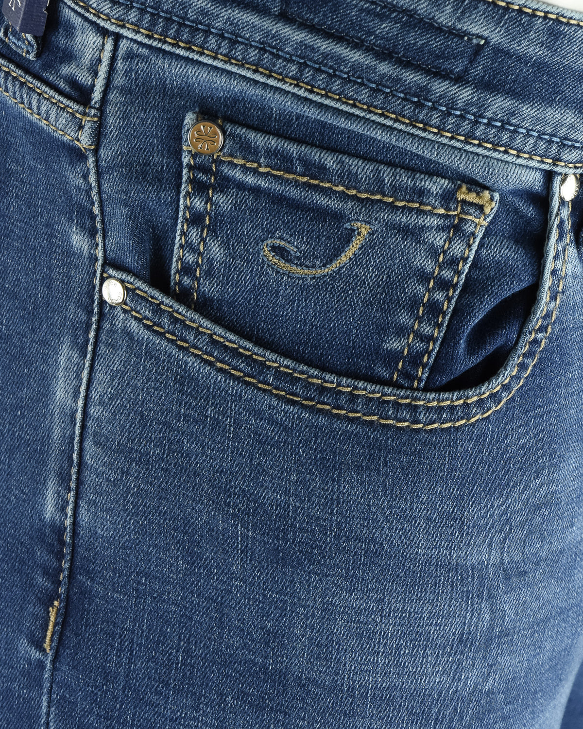 Blue denim jeans with front pocket, belt loops, and metal logo rivet