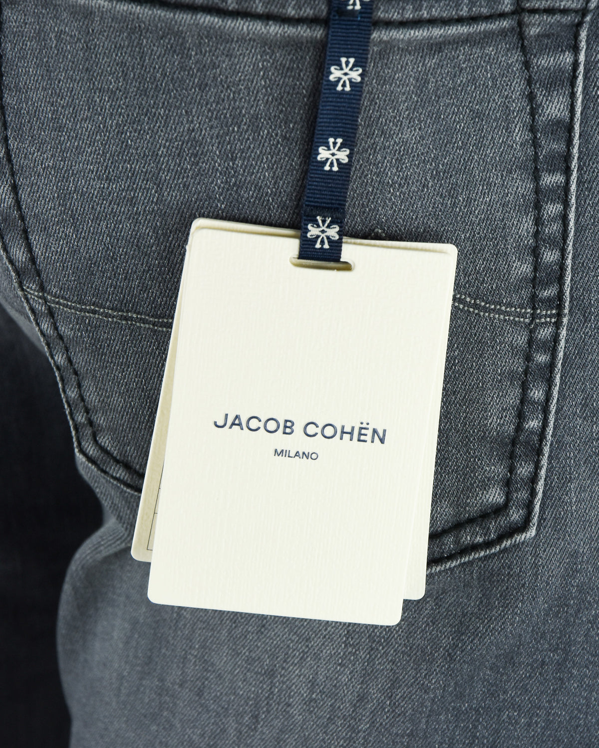 Jacob Cohen Milano hang tag on mid-grey denim jeans with belt loops