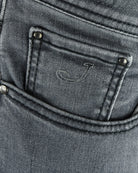 Grey denim coin pocket with stitched border and metal rivets