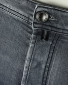 Grey denim button fly with metal button and inner zipper placket